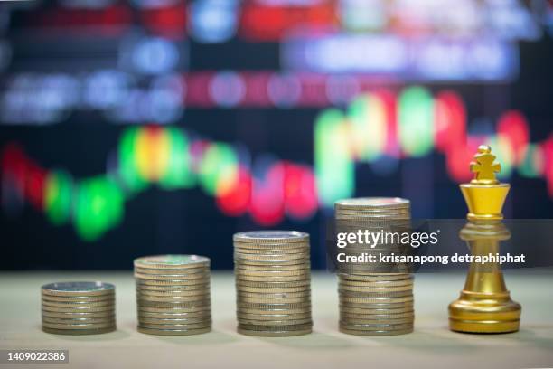 money with chess,gold unicorn chess and business chart ,business concept - cost management stockfoto's en -beelden