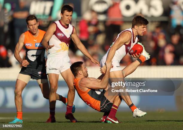 Zac Bailey of the Lions is challenged by Stephen Coniglio of the Giants during the round 18 AFL match between the Greater Western Sydney Giants and...