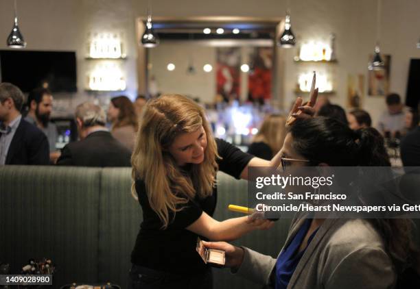 Trendee King, left, with StyleBee shows guest Tara Singh some makeup samples during a Three Day Rule matchmaking event at LV Mar Restaurant in...