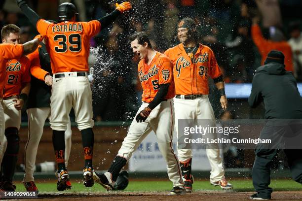 Mike Yastrzemski of the San Francisco Giants celebrates with teammates after hitting a walk-off grand slam in the bottom of the ninth inning against...