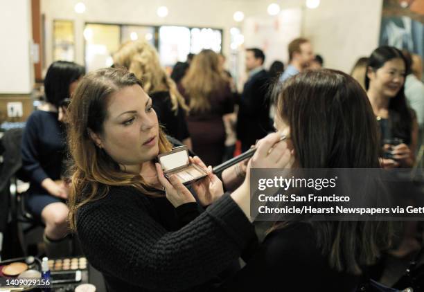 Chantelle Hartshorne with StyleBee shows a guest some makeup samples during a Three Day Rule matchmaking event at LV Mar Restaurant in Redwood City,...