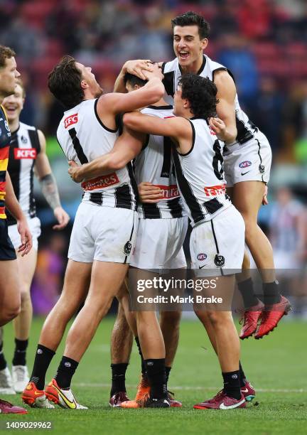 Scott Pendlebury of the Magpies celebrates a goal with Patrick Lipinski Trent Bianco and Nick Daicos of the Magpies during the round 18 AFL match...