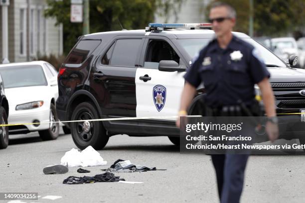 Police officer instructs pedestrians how to get around the investigation scene after a fatal vehicle collision in Alameda, Calif., on Monday, May 29,...