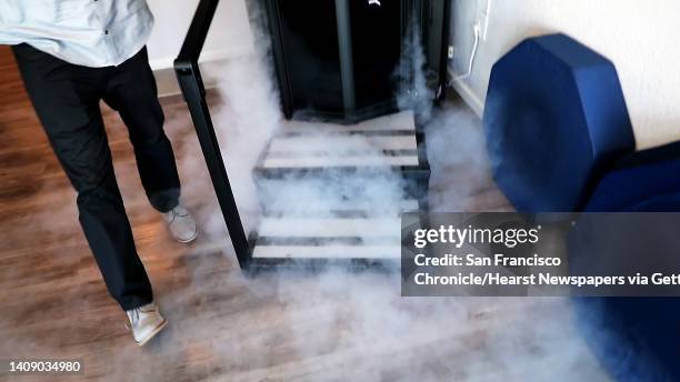 Nitrogen gas escapes from the cryotherapy chamber as San Francisco Chronicle columnist Scott Ostler tries out the latest in sports health therapy,...