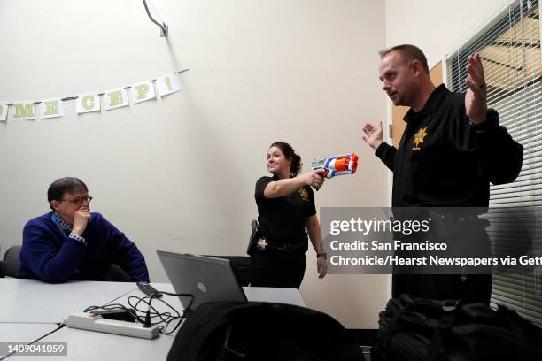 Cpl. Wade McAdam, right, and Sgt. Sabrina Reich role play with a toy gun during an active shooter training session presented by the UC Police on the...