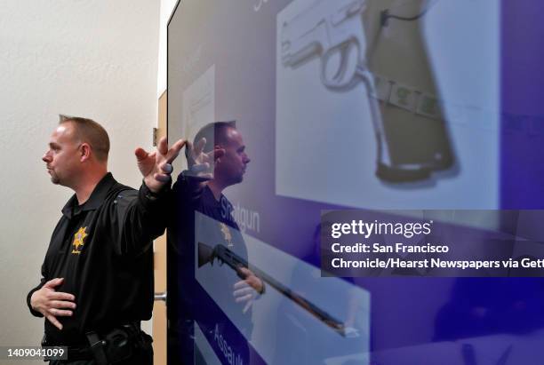 Cpl. Wade McAdam shows students slides of various weapons to help them identify them in the event of a shooting during an active shooter training...