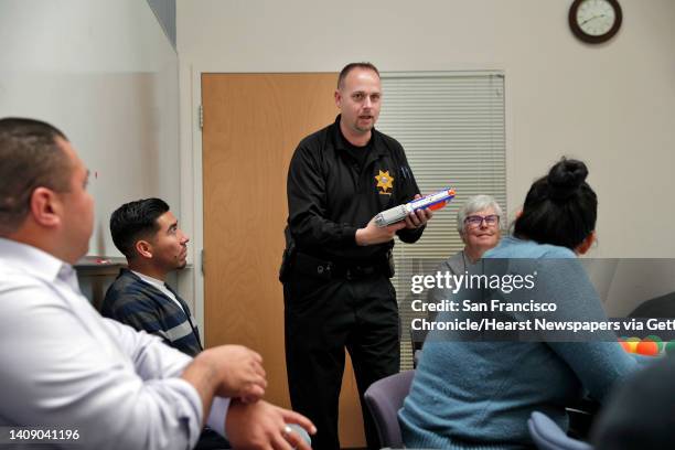 Cpl. Wade McAdam, right, demonstrates the best way to defend themselves against a "shooter" entering a room as they role play with a toy gun during...