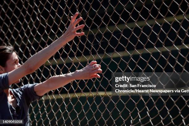 Dancer Britt Juleen climbs the backstop fence at Rikki Streicher Field during a S.F. Dance Film Festival video shoot in San Francisco, Calif., on...