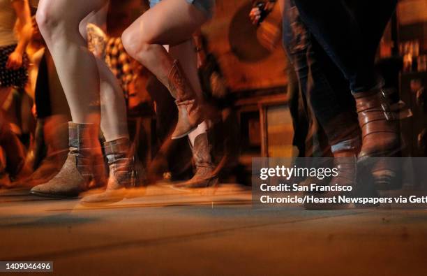 Patrons dance during weekly line dancing lessons at Jaxson, a bar in the Marina that specializes in country music, in San Francisco, Calif., on...