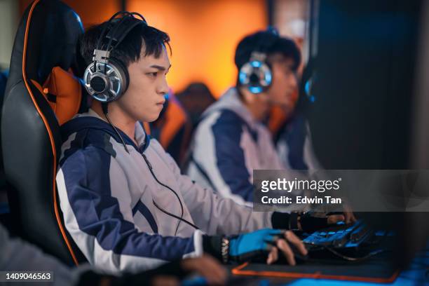 asian chinese esports team gamer focus playing rpg first shooter game in grand final sport event championship arena. cyber games tournament event - mouse pad stock pictures, royalty-free photos & images