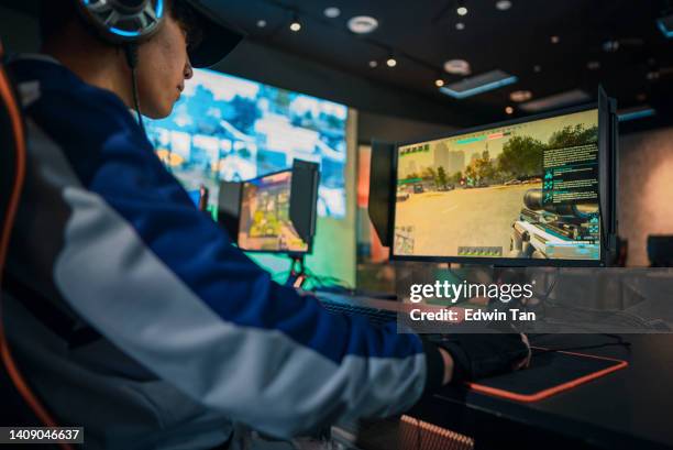 asian esports team gamer focus playing rpg first shooter game in live streaming grand final sport event championship arena. cyber games tournament event - finals game one stockfoto's en -beelden