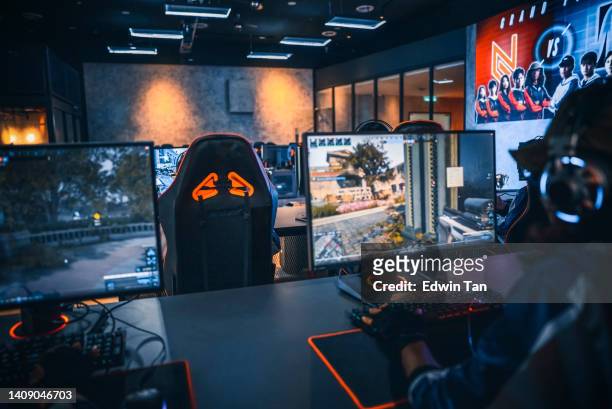 rear view asian chinese esports team gamer focus playing rpg first shooter game in grand final sport event championship arena. cyber games tournament event - back in the game stock pictures, royalty-free photos & images