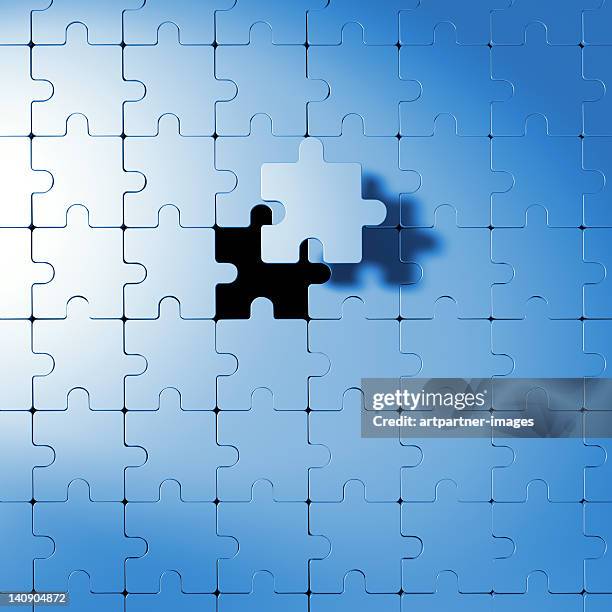 puzzle with last part floating above it - puzzle stock pictures, royalty-free photos & images
