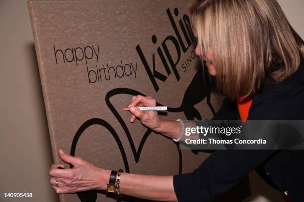 Kipling's President, Julie Dimperio signs a giant birtday card at Kipling's 25th Anniversary Event at Helen Mills Theater on March 7, 2012 in New...