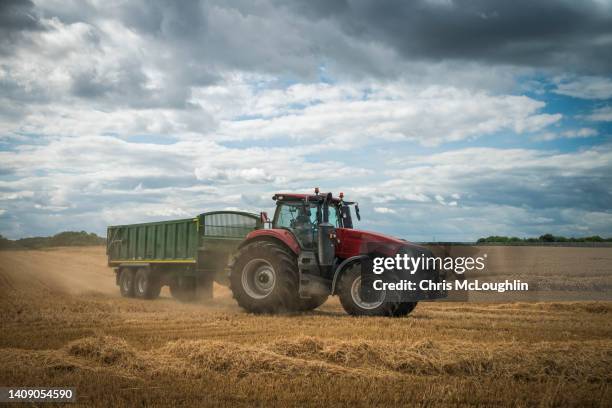 wheat harvest in north yorkshire - tractor stock pictures, royalty-free photos & images