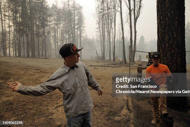 Jeramy Isom, left, and Roy Kirk of Clear Lake, look over the devastation at Hoberg's Resort and Spa in Loch Lomond, Calif., on Sunday, September 13...