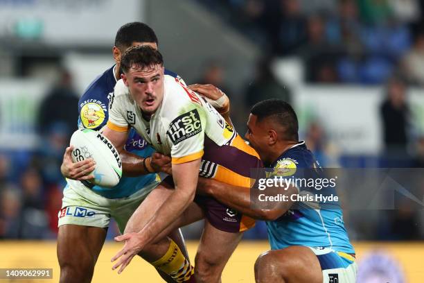 Kobe Hetherington of the Broncos is tackle during the round 18 NRL match between the Gold Coast Titans and the Brisbane Broncos at Cbus Super...