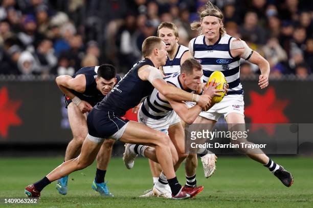 Patrick Cripps of the Blues tackles Joel Selwood of the Cats during the round 18 AFL match between the Carlton Blues and the Geelong Cats at...