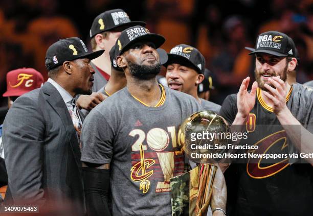 Cleveland Cavaliers' LeBron James holds the the Larry O’Brien NBA Championship Trophy after defeating Golden State Warriors 93 to 89 in Game 7 of the...