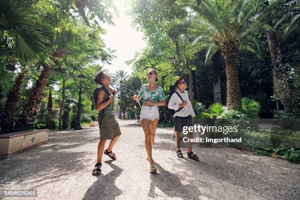 teenagers walking in elche public park. - slow motion stock pictures, royalty-free photos & images