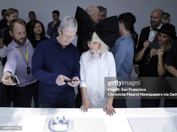 Apple CEO Tim Cook shows the new iPhone 7 to dancer Maddie Ziegler during an Apple Event to announce new products at the Bill Graham Civic Auditorium...