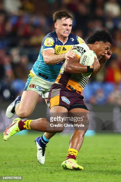 Tesi Niu of the Broncos is tackled by Alexander Brimson of the Titans during the round 18 NRL match between the Gold Coast Titans and the Brisbane...