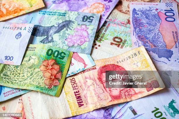 argentine pesos of different values. money from argentina in cash. - argentina fotografías e imágenes de stock