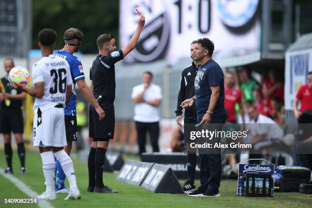 Referee Michael Bacher shows the red card to head coach Uli Forte of Bielefeld during the Second Bundesliga match between SV Sandhausen and DSC...