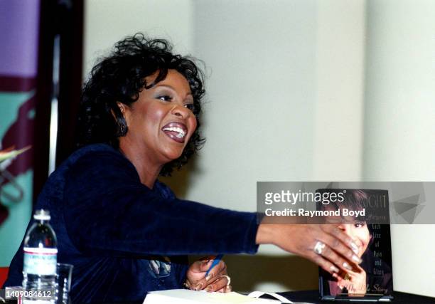 Singer Gladys Knight signs autographs and greets fans during her 'Between Each Line of Pain and Glory: My Life Story' book signing at Afrocentric...