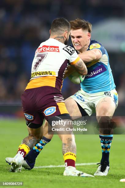 Alexander Brimson of the Titans is tackled during the round 18 NRL match between the Gold Coast Titans and the Brisbane Broncos at Cbus Super...