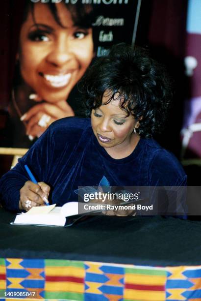 Singer Gladys Knight signs autographs and greets fans during her 'Between Each Line of Pain and Glory: My Life Story' book signing at Afrocentric...