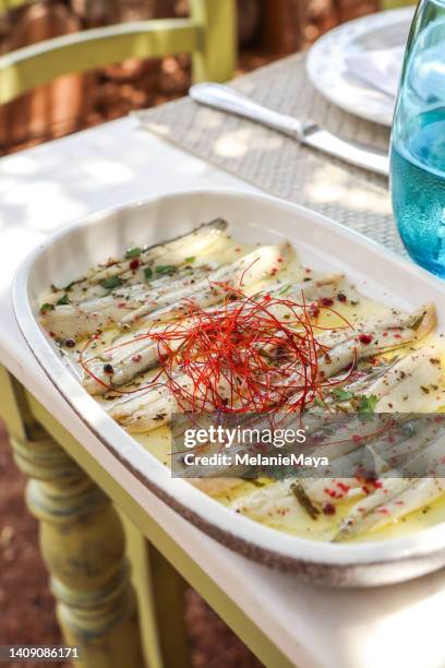 greek food appetizer sardines with olive oil and saffron pepper - sardine stock pictures, royalty-free photos & images