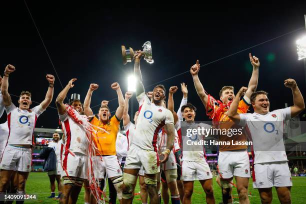 Courtney Lawes of England and teammates celebrate victory with the Ella-Mobbs Cup during game three of the International Test match series between...