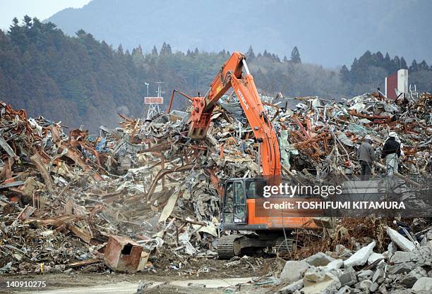 Heavy machinery removes the remnents of tsunami devastation in Rikuzentakata city, Iwate prefectura on March 8, 2012. Japan is readying to mark the...