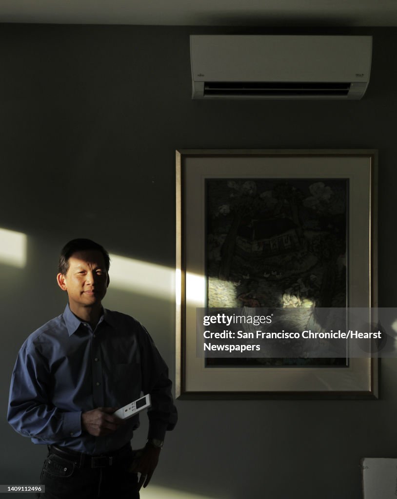 Wei-Tai Kwok next to the ductless heating/cooling system at his home that he completely converted to electric to stop using natural gas in Lafayette, Calif., on Monday, December 16, 2019. In January, new state requirements requiring rooftop solar panels o