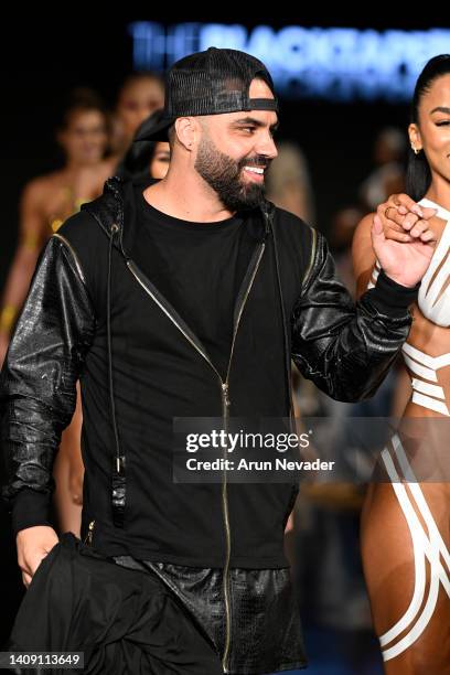 Designer Joel Alvarez walks the runway wearing Black Tape Project at Miami Swim Week powered by Art Hearts Fashion at Faena Forum on July 15, 2022 in...