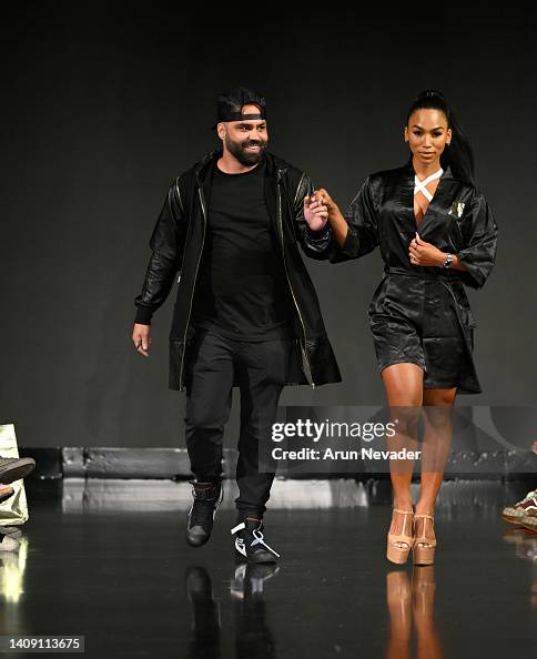 Designer Joel Alvarez and a model walk the runway wearing Black Tape ...