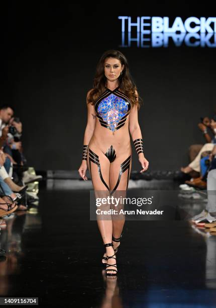 Model walks the runway wearing Black Tape Project at Miami Swim Week powered by Art Hearts Fashion at Faena Forum on July 15, 2022 in Miami Beach,...