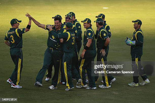 Clint McKay of Australia celebrates with team mates after dismissing Dinesh Chandimal of Sri Lanka for lbw during the third One Day International...