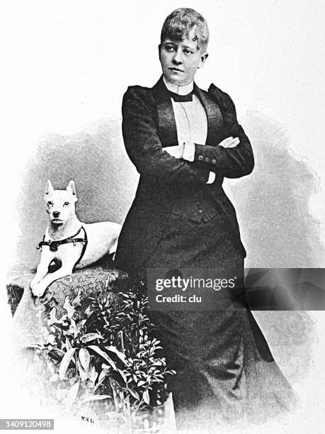 adele sandrock, actress, standing at a table with dog - adele sandrock stock illustrations