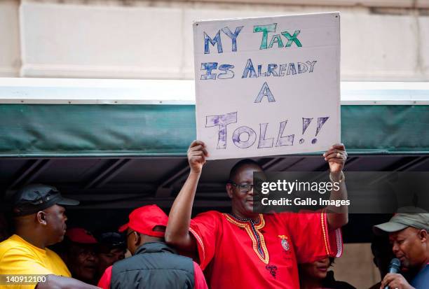 General Secretary Zwelinzima Vavi holds up a placard during a protest march held by members of COSATU and other trade unions on March 7, 2012 in...