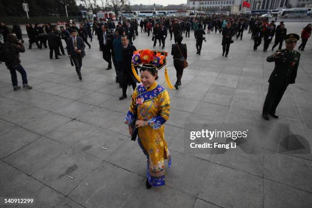 Female ethnic minority delegate wearing a traditional costume arrives at The Great Hall Of The People before the second plenary meeting of the...