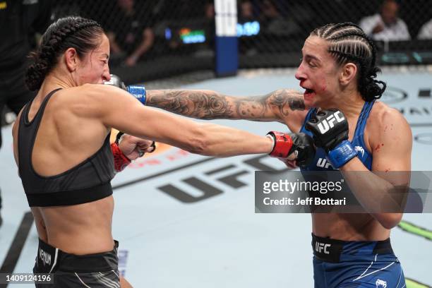 Emily Ducote punches Jessica Penne in a strawweight fight during the UFC Fight Night event at UBS Arena on July 16, 2022 in Elmont, New York.