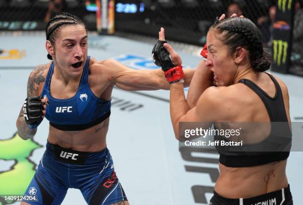 Emily Ducote punches Jessica Penne in a strawweight fight during the UFC Fight Night event at UBS Arena on July 16, 2022 in Elmont, New York.