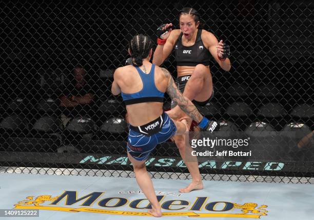 Emily Ducote kicks the leg of Jessica Penne in a strawweight fight during the UFC Fight Night event at UBS Arena on July 16, 2022 in Elmont, New York.