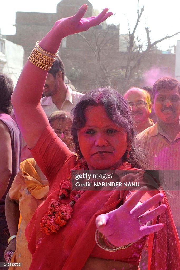 Indian Hindu devotees cover each other w