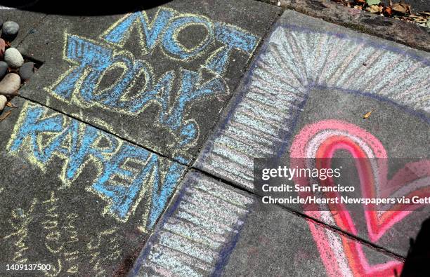 An anti-racism chalk message on the sidewalk outside the home which has been covered in supportive chalk art in San Francisco, Calif., on Monday,...