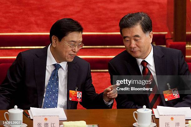 Zhang Dejiang, vice premier of China, left, speaks with Wang Yang, Chinese Communist Party secretary of Guangdong Province, at a plenary session on...