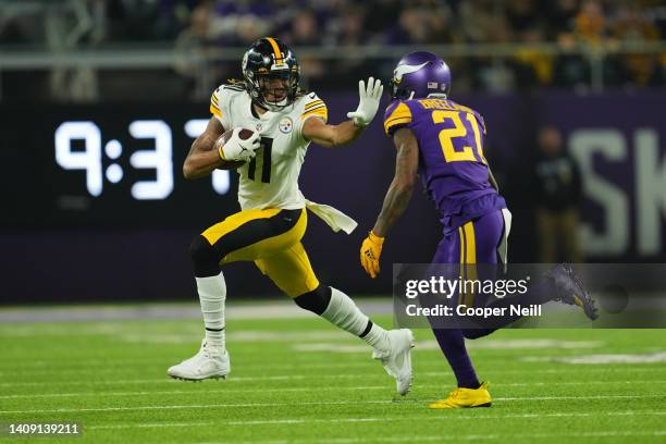 Chase Claypool of the Pittsburgh Steelers stiff-arms Brashaud Breeland of the Minnesota Vikings during an NFL game at U.S. Bank Stadium on December...