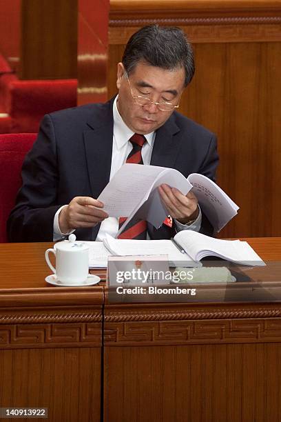 Wang Yang, Chinese Communist Party secretary of Guangdong Province, reads a document at a plenary session on the draft amendment to the Criminal...